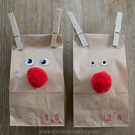 two brown bags decorated like reindeer